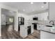 Well-equipped kitchen featuring stainless steel appliances, island and white cabinets at 41678 N Salix Dr, San Tan Valley, AZ 85140