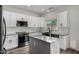 Modern kitchen features a kitchen island, stainless steel appliances, and white cabinetry at 41678 N Salix Dr, San Tan Valley, AZ 85140