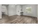 Bright living room featuring a modern chandelier, wood-look flooring, and a bright entrance at 41678 N Salix Dr, San Tan Valley, AZ 85140