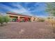 Expansive backyard features mature landscaping, a covered patio, and desert-style rock groundcover at 4571 N Arbor Way, Buckeye, AZ 85396