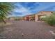 Desert backyard features a spacious open area with desert rock groundcover and some desert-style landscaping at 4571 N Arbor Way, Buckeye, AZ 85396
