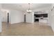 Spacious room with tile flooring leading to kitchen at 4571 N Arbor Way, Buckeye, AZ 85396