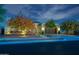 Inviting home exterior featuring beautiful landscaping and a two-car garage at twilight at 4571 N Arbor Way, Buckeye, AZ 85396
