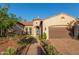Charming home showcasing meticulous landscaping and a welcoming brick driveway at 4571 N Arbor Way, Buckeye, AZ 85396