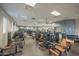 Spacious fitness center with a variety of modern exercise equipment and multiple TVs on the wall at 4571 N Arbor Way, Buckeye, AZ 85396