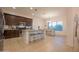 Bright eat-in kitchen featuring dark cabinets, stainless appliances, and breakfast bar at 4571 N Arbor Way, Buckeye, AZ 85396