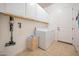 Laundry room with ample cabinet storage, washer, and dryer at 4571 N Arbor Way, Buckeye, AZ 85396