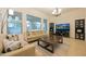 Bright living room featuring neutral furniture, large windows, and stylish decor at 4571 N Arbor Way, Buckeye, AZ 85396