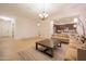 Open-concept living area with tile floors, neutral decor, and kitchen access at 4571 N Arbor Way, Buckeye, AZ 85396
