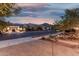 A serene street view of homes in a residential neighborhood with mountains in the distance at 4571 N Arbor Way, Buckeye, AZ 85396