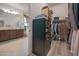 A walk-in closet adjacent to a bathroom features built in closet organizers at 4571 N Arbor Way, Buckeye, AZ 85396