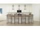 Modern kitchen with white cabinets, stainless appliances, island with bar stool seating at 4642 E Topaz Dr, San Tan Valley, AZ 85143