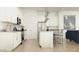 Bright kitchen features white cabinets, stainless steel appliances, and island with seating at 4642 E Topaz Dr, San Tan Valley, AZ 85143