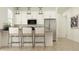Bright kitchen with an island, stainless appliances, and modern bar stool seating at 4642 E Topaz Dr, San Tan Valley, AZ 85143