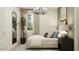 Cozy bedroom featuring a modern chandelier, full length mirror, and neutral tones for a relaxing atmosphere at 4695 E Topaz Dr, San Tan Valley, AZ 85143