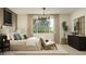 Serene bedroom with a plush bed, stylish decor, natural light, and a cozy chair near the window at 4695 E Topaz Dr, San Tan Valley, AZ 85143