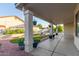 Inviting covered backyard patio with lush landscaping and decorative potted plants, perfect for outdoor relaxation at 47 W Calle Monte Vis, Tempe, AZ 85284