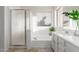 Bright bathroom with a shower, bathtub, vanity, and tile flooring at 47 W Calle Monte Vis, Tempe, AZ 85284