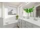 Bathroom featuring a bathtub, vanity, and window for natural light at 47 W Calle Monte Vis, Tempe, AZ 85284