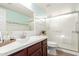 Bathroom with framed mirror, vanity, tiled shower with glass doors, and new fixtures at 47 W Calle Monte Vis, Tempe, AZ 85284