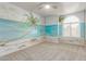 Bedroom featuring custom beach mural, ceiling fan, neutral carpet, and ample natural light at 47 W Calle Monte Vis, Tempe, AZ 85284