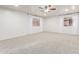 Large carpeted bedroom featuring neutral walls, ceiling fan, and ample natural light at 47 W Calle Monte Vis, Tempe, AZ 85284
