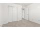 Bedroom featuring neutral carpet, spacious closet, and bright white walls and trim at 47 W Calle Monte Vis, Tempe, AZ 85284