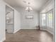 Bright dining room features wood floors, stylish light fixture, and large windows for ample natural light at 47 W Calle Monte Vis, Tempe, AZ 85284