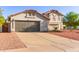 Well-maintained home boasts desert landscaping, tile roof, and a spacious driveway leading to a gray garage door at 47 W Calle Monte Vis, Tempe, AZ 85284