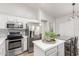 Stylish kitchen featuring stainless steel appliances, a kitchen island, and modern countertops at 47 W Calle Monte Vis, Tempe, AZ 85284