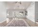Stylish living room with hardwood floors, shiplap accent wall, modern ceiling fan, and access to outdoor space at 47 W Calle Monte Vis, Tempe, AZ 85284