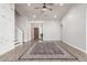 Open living room with hardwood floors, a ceiling fan, and a view of the front entry at 47 W Calle Monte Vis, Tempe, AZ 85284