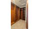 Walk-in closet with wood shelving and ample storage space at 4730 N 111Th Ln, Phoenix, AZ 85037