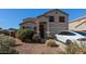 Charming home with a well-maintained front yard, red shutters, and a Tesla in the driveway at 4730 N 111Th Ln, Phoenix, AZ 85037