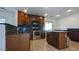 Kitchen with dark cabinets and stainless steel appliances at 4730 N 111Th Ln, Phoenix, AZ 85037