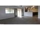 Bright living room featuring plush carpeting, backyard access, and direct access to the kitchen at 4730 N 111Th Ln, Phoenix, AZ 85037