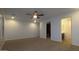 Spacious main bedroom with ample natural light, plush carpeting, and adjoining bathroom at 4730 N 111Th Ln, Phoenix, AZ 85037