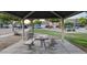 Community picnic area with shaded pavilion and concrete table and benches at 4730 N 111Th Ln, Phoenix, AZ 85037