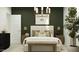 Stylish bedroom features a dark green accent wall, warm lighting, and refined decor elements at 4732 E Amethyst Ln, San Tan Valley, AZ 85143