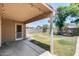Covered patio with string lights leads to a spacious backyard and block fence at 4948 W Wikieup Ln, Glendale, AZ 85308