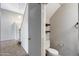Cozy bathroom features a toilet, with wood floating shelves for added storage at 4948 W Wikieup Ln, Glendale, AZ 85308