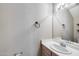 Bathroom features a large mirror, a white sink, and a decorative towel rack at 4948 W Wikieup Ln, Glendale, AZ 85308
