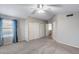 Large bedroom featuring a ceiling fan, closet, and doorway leading to another room at 4948 W Wikieup Ln, Glendale, AZ 85308