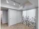 Bright bedroom with tile floors, large closet, and floral-patterned curtains providing natural light at 4948 W Wikieup Ln, Glendale, AZ 85308
