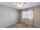 Bright bedroom featuring a window with curtains, neutral carpet, and freshly painted walls at 4948 W Wikieup Ln, Glendale, AZ 85308