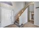 Inviting entryway with tiled floors and carpeted stairs with a wooden handrail at 4948 W Wikieup Ln, Glendale, AZ 85308