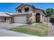 Charming two-story home featuring a tile roof, a two-car garage, and a well-maintained front yard with lovely flowers at 4948 W Wikieup Ln, Glendale, AZ 85308