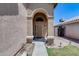 Inviting front entrance with a covered archway, well-lit walkway, and manicured landscaping creating curb appeal at 4948 W Wikieup Ln, Glendale, AZ 85308