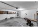 Spacious garage with ample storage space and a modern lawnmower at 4948 W Wikieup Ln, Glendale, AZ 85308