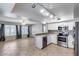 Bright kitchen featuring stainless steel appliances, white cabinets and seamless flow into living area at 4948 W Wikieup Ln, Glendale, AZ 85308